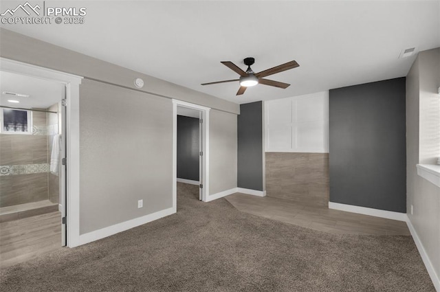 unfurnished room with carpet floors, ceiling fan, visible vents, and baseboards