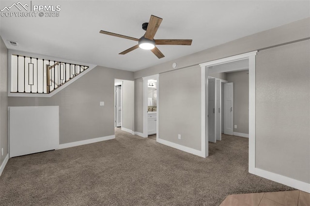 unfurnished living room featuring visible vents, stairs, baseboards, and carpet flooring