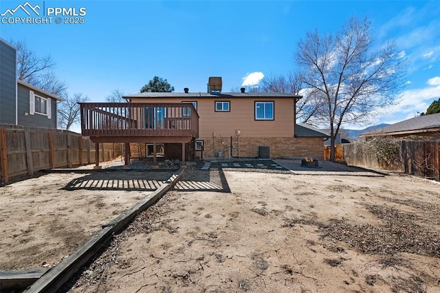 back of house with central AC unit, a patio, a fenced backyard, a wooden deck, and brick siding