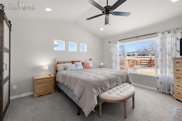 bedroom featuring vaulted ceiling, a barn door, light colored carpet, and baseboards