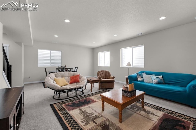 living room featuring carpet, baseboards, recessed lighting, stairs, and a textured ceiling