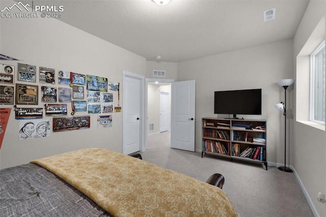 bedroom with visible vents, carpet flooring, and baseboards