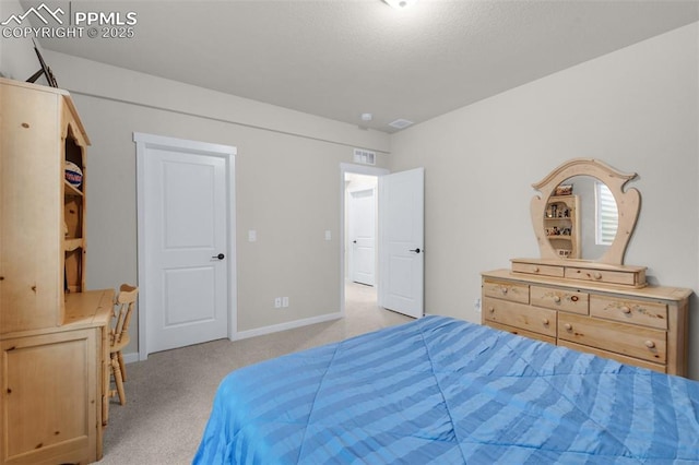 carpeted bedroom featuring visible vents and baseboards