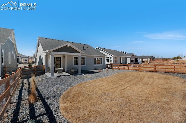 back of house with a yard, a fenced backyard, and a patio area