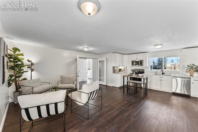 living room with dark wood-style floors and baseboards