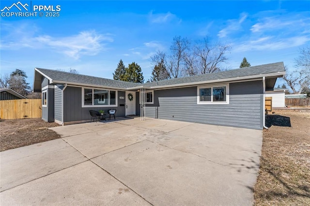 ranch-style home with driveway, a patio area, and fence