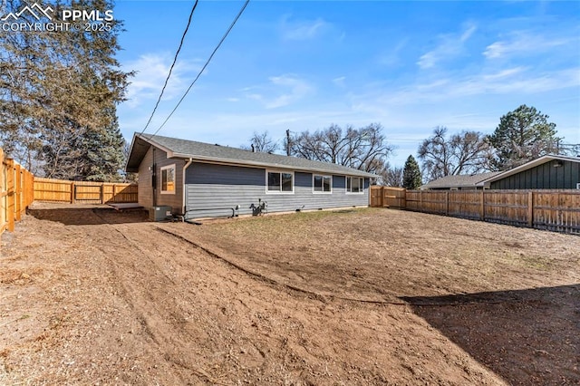 back of property with a fenced backyard