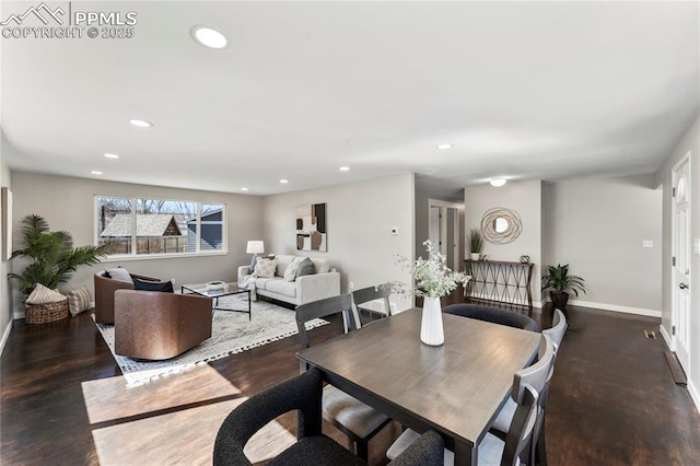 dining area featuring baseboards, wood finished floors, and recessed lighting