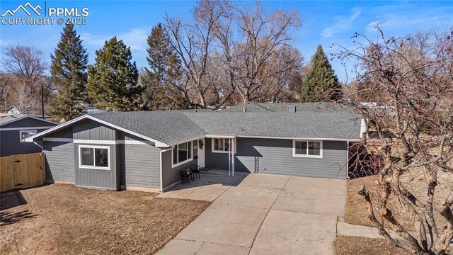 single story home with roof with shingles, a patio area, and fence