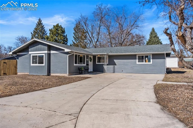 single story home with roof with shingles, driveway, and fence