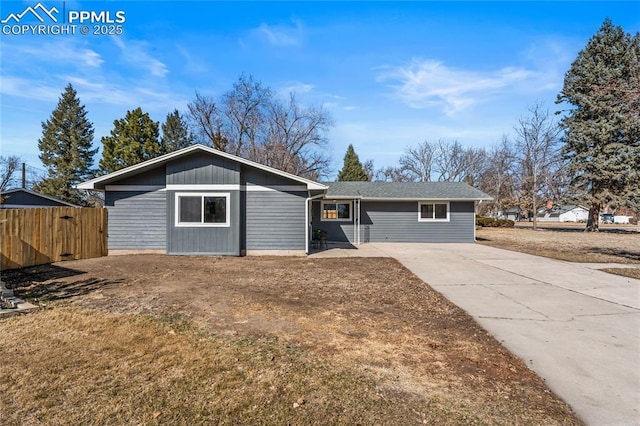 single story home featuring fence