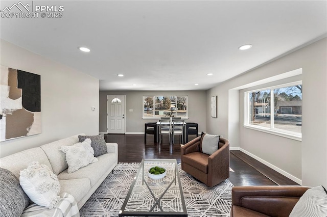 living room with recessed lighting, baseboards, and wood finished floors