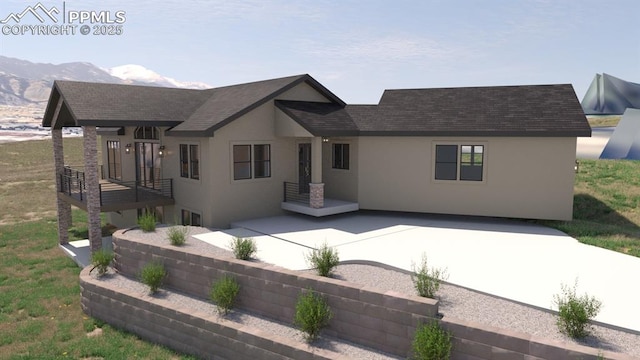240 N Limit St, Colorado Springs, CO 80904 - back of house with stucco siding, a shingled roof, and a mountain view