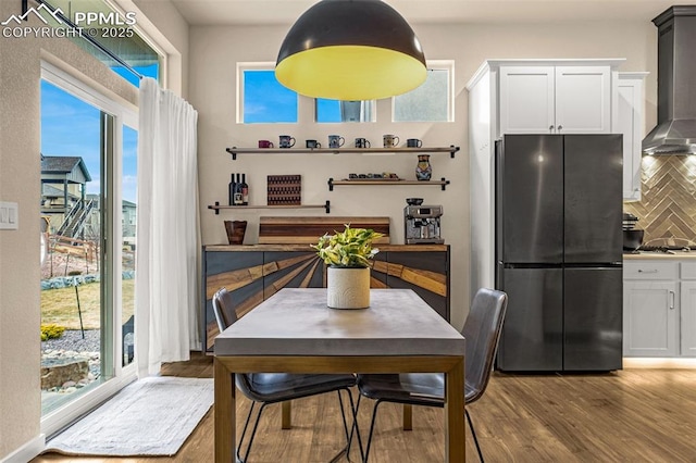 dining space with wood finished floors