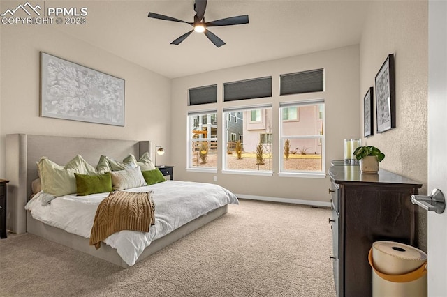 carpeted bedroom featuring baseboards and a ceiling fan