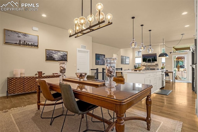 dining space with visible vents, baseboards, wood finished floors, and recessed lighting