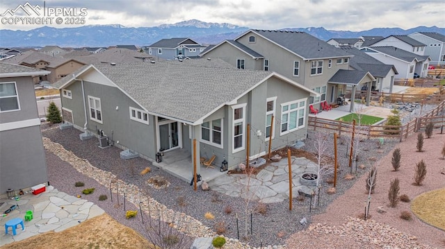 back of house featuring a residential view, a patio, and a mountain view