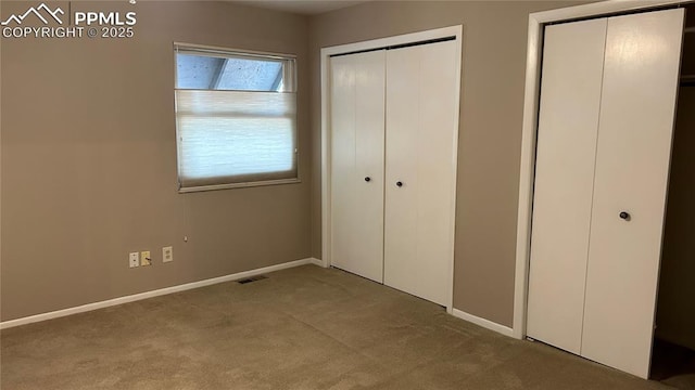 unfurnished bedroom featuring baseboards, visible vents, and carpet floors