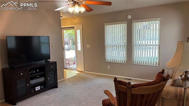 living area with light carpet, visible vents, baseboards, and a ceiling fan