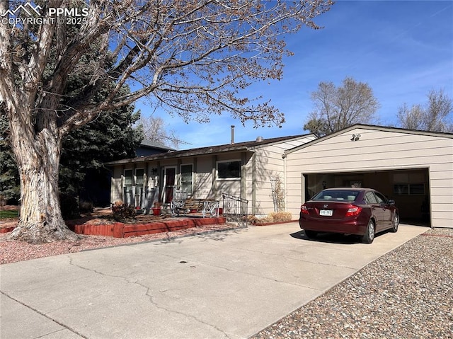 ranch-style home with an attached garage and driveway