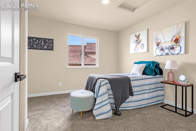 bedroom with carpet, attic access, and baseboards