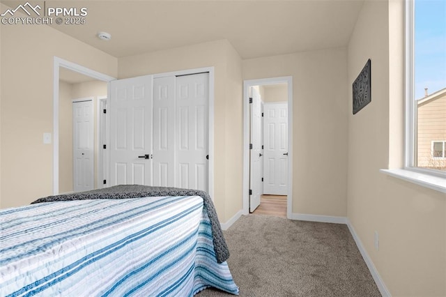 bedroom featuring a closet, carpet flooring, and baseboards