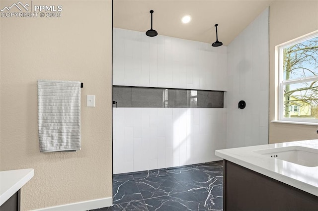 full bathroom with marble finish floor, recessed lighting, walk in shower, and vanity