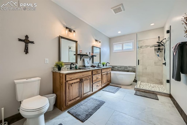 bathroom with toilet, a sink, a soaking tub, a shower stall, and double vanity