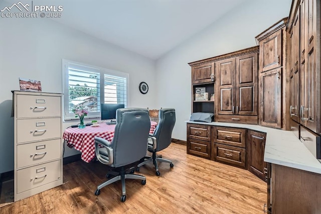 office area featuring vaulted ceiling and light wood-style floors