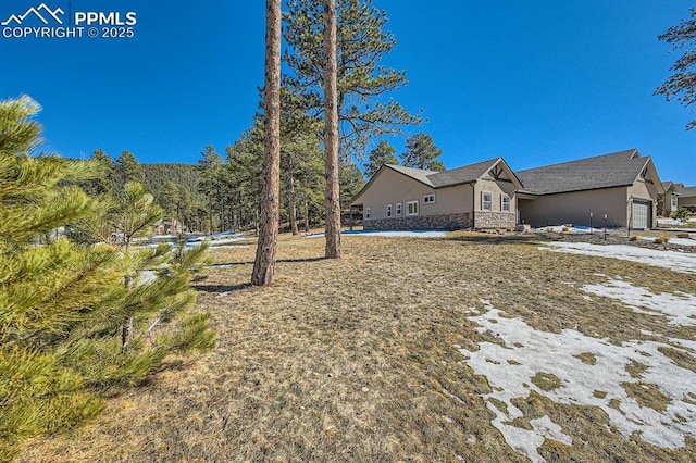 view of home's exterior with stone siding and stucco siding