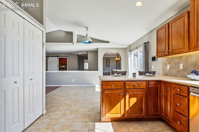 7619 High Gate Dr, Fountain, CO 80817 - kitchen featuring arched walkways, vaulted ceiling, light countertops, decorative backsplash, and dishwasher