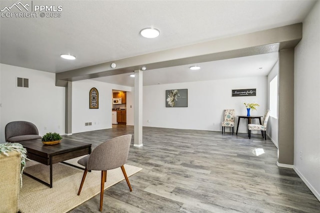 7619 High Gate Dr, Fountain, CO 80817 - living area with visible vents, baseboards, and wood finished floors