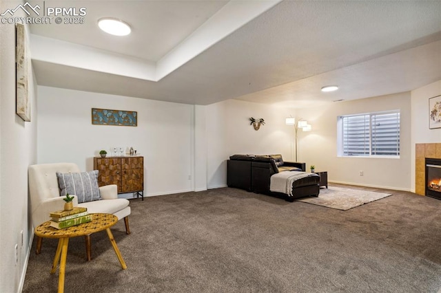 7619 High Gate Dr, Fountain, CO 80817 - living area with carpet floors, a tile fireplace, and baseboards