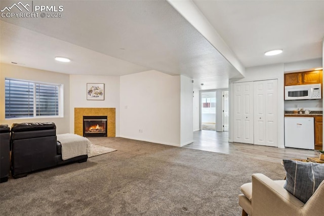 7619 High Gate Dr, Fountain, CO 80817 - living room with a tile fireplace, baseboards, and light colored carpet