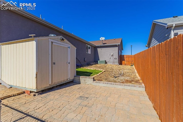 7619 High Gate Dr, Fountain, CO 80817 - exterior space with central AC unit, an outdoor structure, fence, a storage unit, and a patio area