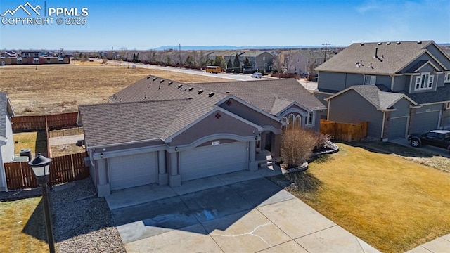 7619 High Gate Dr, Fountain, CO 80817 - view of front of home featuring a garage, a residential view, fence, and concrete driveway