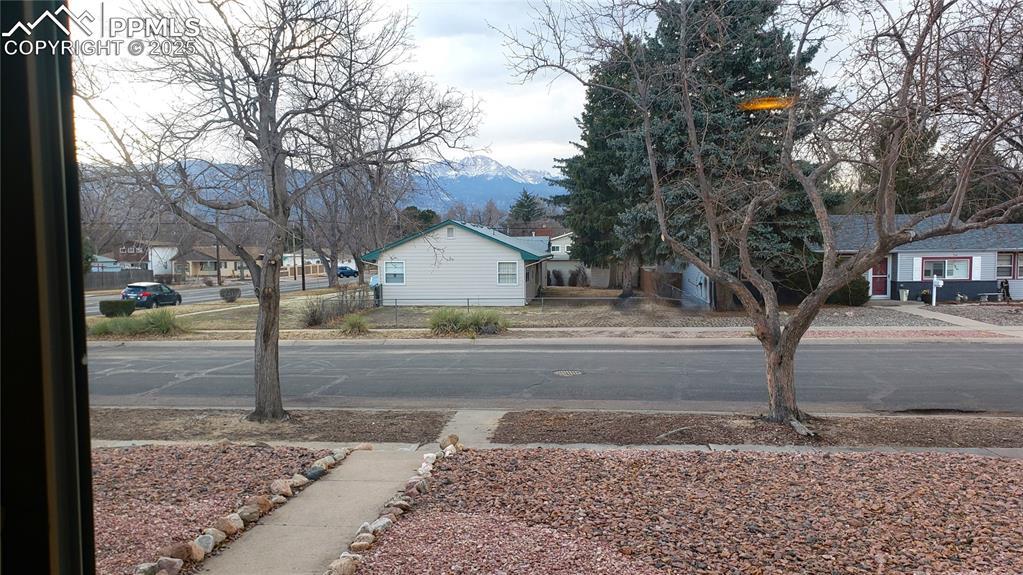 view of road with curbs, sidewalks, and a mountain view