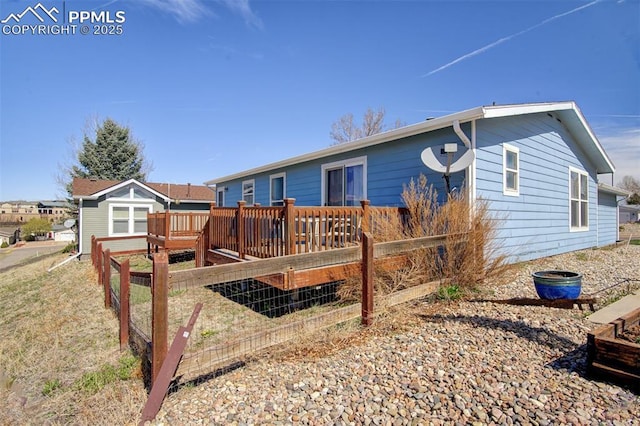 back of house with a wooden deck