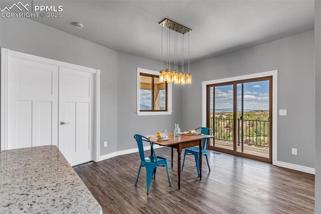 dining space with baseboards, dark wood finished floors, visible vents, and a notable chandelier