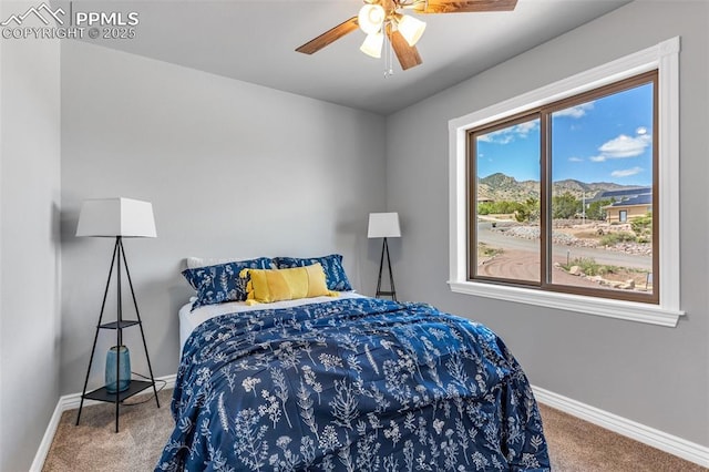 bedroom featuring ceiling fan, carpet, and baseboards