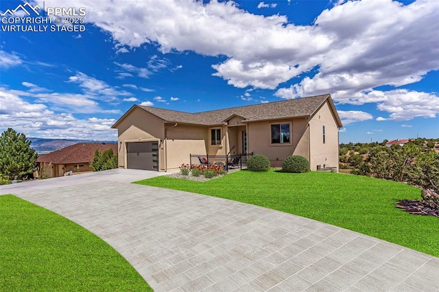 single story home with a front lawn, decorative driveway, an attached garage, and stucco siding