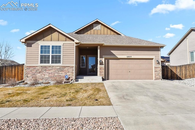 craftsman house with board and batten siding, concrete driveway, an attached garage, and fence