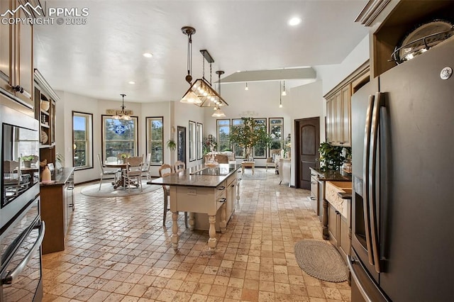 kitchen featuring recessed lighting, a kitchen island, a kitchen breakfast bar, appliances with stainless steel finishes, and pendant lighting