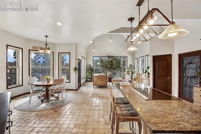 dining area with a high ceiling and baseboards