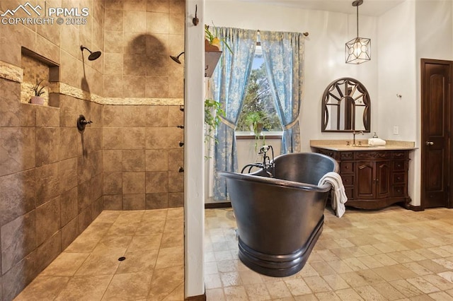 bathroom featuring a tile shower, vanity, and a freestanding bath