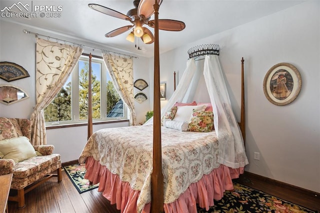 bedroom with dark wood-style floors, ceiling fan, and baseboards