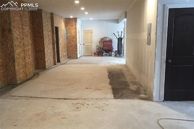 corridor featuring recessed lighting and unfinished concrete floors