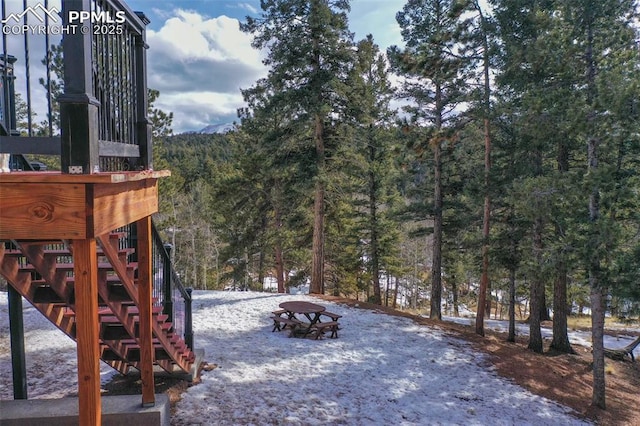 view of yard featuring a fire pit and a wooded view