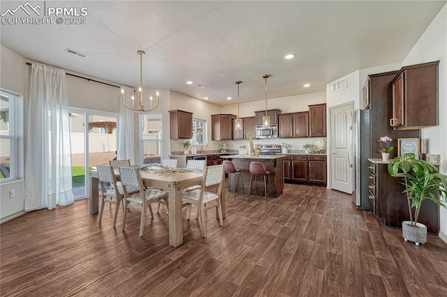 dining room featuring a notable chandelier, dark wood-style flooring, visible vents, and recessed lighting