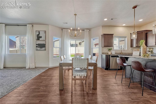 dining room with visible vents, dark wood-style floors, a textured ceiling, a notable chandelier, and recessed lighting